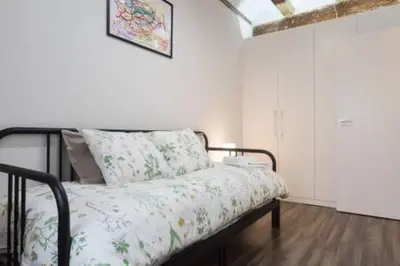 a bed in a white room with a bedspread on it at Your home at Valencia, Cabañal in Valencia