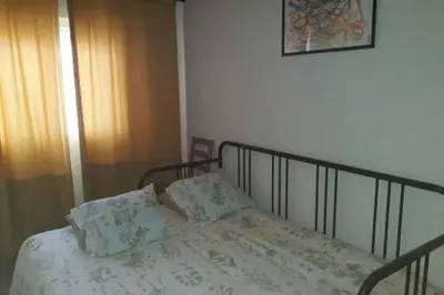 a bed with two pillows on it in a bedroom at Your home at Valencia, Cabañal in Valencia