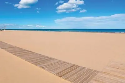 a sandy beach with the ocean in the background at Your home at Valencia, Cabañal in Valencia