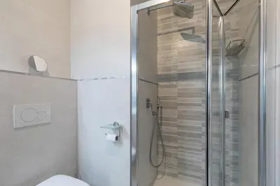 a bathroom with a shower and a toilet in it at Luxury Beach Front Apartment with Pool in Valencia