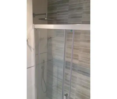 a shower in a bathroom with a glass door at Luxury Beach Front Apartment with Pool in Valencia