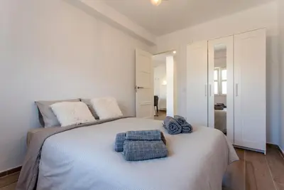 a bedroom with a bed with towels on it at Valencia Flat Rental Malvarrosa Beach zone in Valencia