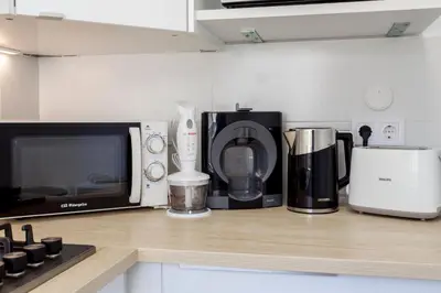 a kitchen counter with a microwave and various appliances at Valencia Flat Rental Malvarrosa Beach zone in Valencia