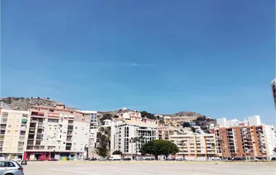 a parking lot with buildings in front of a city at 1 Bedroom Nice Apartment In Cullera in Cullera
