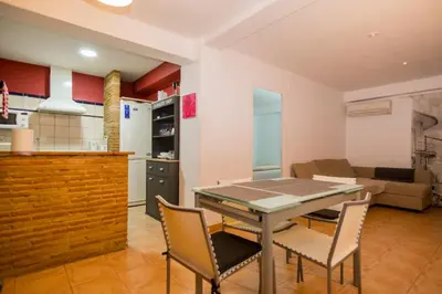 a kitchen and living room with a table and chairs at Casco antiguo, el Carmen. in Valencia