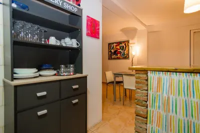 a kitchen with a black cabinet and a table at Casco antiguo, el Carmen. in Valencia