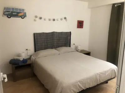 a bedroom with a white bed with a black headboard at Casco antiguo, el Carmen. in Valencia