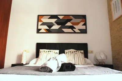 a bedroom with a bed with a picture on the wall at Ruzafa, centro ciudad. Terraza-wifi in Valencia