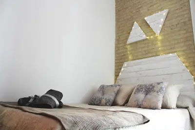 a bedroom with a bed with a window on the wall at Ruzafa, centro ciudad. Terraza-wifi in Valencia