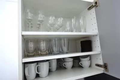 a cupboard filled with glasses and mugs at Apartamento Justina in Cullera