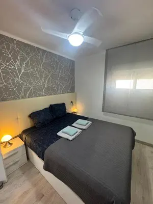 a bedroom with a bed with two towels on it at Apartamento Justina in Cullera