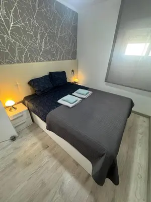 a bedroom with a bed with two towels on it at Apartamento Justina in Cullera
