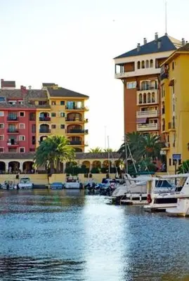 a marina with boats in the water next to buildings at Valencia Beach room with private bathroom coliving in Port Saplaya