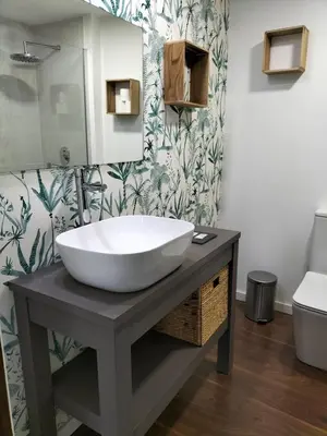 a shower with a glass door next to a toilet at Valencia Beach room with private bathroom coliving in Port Saplaya