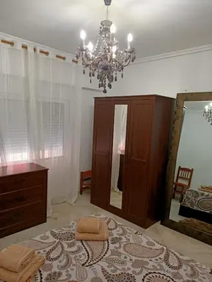 a bathroom with a mirror and a chandelier at el piso perfecto in Puerto de Sagunto