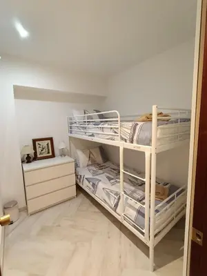 a bedroom with two bunk beds and a dresser at el piso perfecto in Puerto de Sagunto