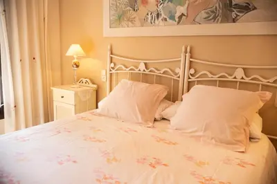 a bed with white sheets and pillows in a bedroom at Casa Rural La Torreta in Corbera de Alcira