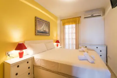 a bedroom with a white bed and a window at ApartUP Saplaya Harbour in Alboraya