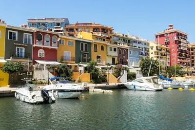 a group of boats docked in a harbor with buildings at ApartUP Saplaya Harbour in Alboraya