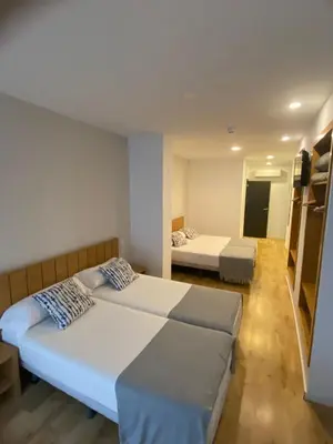 a bedroom with two beds and a room with twounks at Nanit Valencia Hostel in Valencia