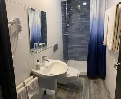 a bathroom with a sink and a toilet and a shower at Nanit Valencia Hostel in Valencia