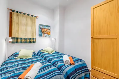 a bedroom with two beds with towels on them at Beach Apartment with beautiful view in Port Saplaya
