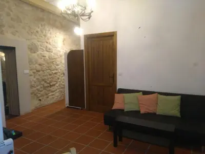 a living room with a couch with pillows on it at Casa Rural La Tia Rosa in Chulilla