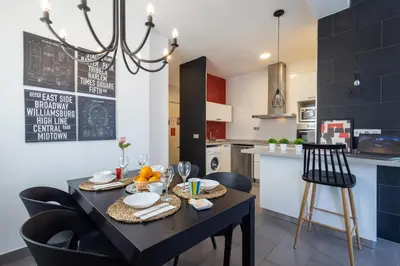 a living room with a couch and a table at FLORIT FLATS - Stylish 2 Bedroom AC Wifi Terrace Attic in Valencia Center in Valencia