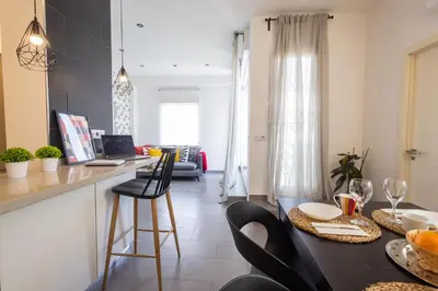 a kitchen and living room with a table with oranges on it at FLORIT FLATS - Stylish 2 Bedroom AC Wifi Terrace Attic in Valencia Center in Valencia