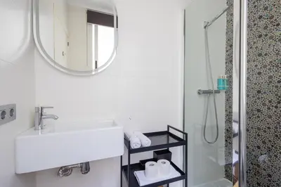 a bedroom with a bed with a black wall at FLORIT FLATS - Stylish 2 Bedroom AC Wifi Terrace Attic in Valencia Center in Valencia