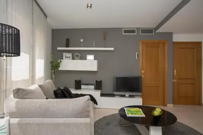 a living room with a couch and a tv at SingularStays Poeta Querol in Valencia
