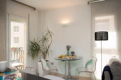a living room with a table and chairs at SingularStays Poeta Querol in Valencia