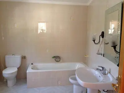 a bathroom with a toilet and a tub and a sink at Chalet en el Monte con Piscina in Sagunto