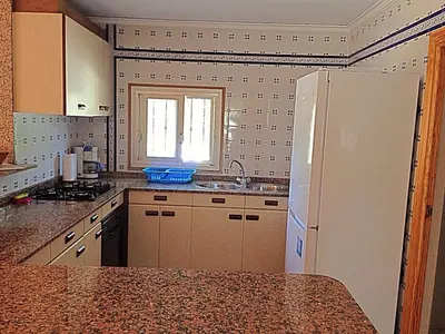 a kitchen with a white refrigerator and a sink at Chalet en el Monte con Piscina in Sagunto