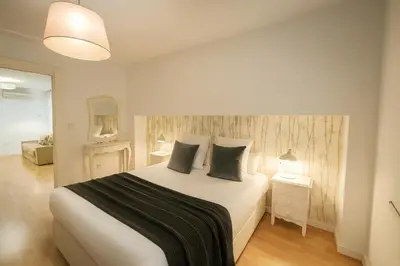 a bedroom with a large bed with two pillows at FLORIT FLATS - The Jardines del Turia Apartment in Valencia