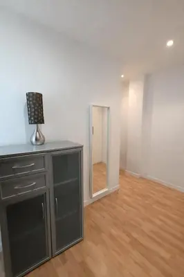 a room with a mirror and a dresser with a lamp at FLORIT FLATS - The Jardines del Turia Apartment in Valencia