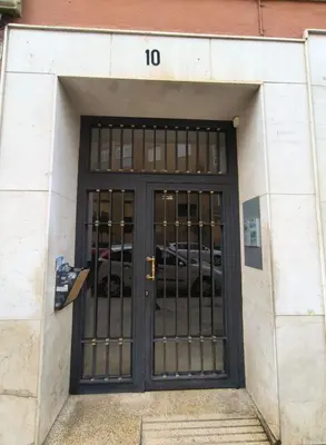 a door to a parking lot with cars behind it at FLORIT FLATS - The Jardines del Turia Apartment in Valencia