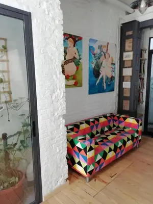 a room with a bed and a tv and a couch at Loft Valencia Playa in Valencia