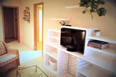 a kitchen with a washing machine and a microwave at Little Venice apartment in Alboraya