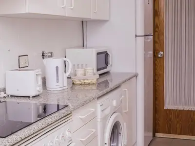 a kitchen with white cabinets and a counter top at Little Venice apartment in Alboraya