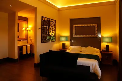 a bedroom with a bed and a chair in it at Hotel Spa Martín el Humano in Segorbe