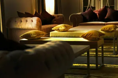 a living room with two couches and two tables with pillows at Hotel Spa Martín el Humano in Segorbe
