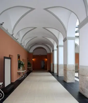 an empty hallway with white arches in a building at Hotel Spa Martín el Humano in Segorbe