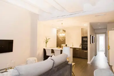 a living room with a couch and a kitchen at MD Julio Antonio in Valencia