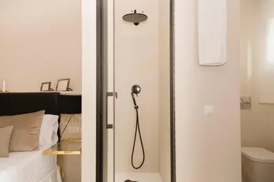 a shower in a small room with a bed at MD Julio Antonio in Valencia
