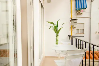 a white table and a chair on a balcony at MD Julio Antonio in Valencia