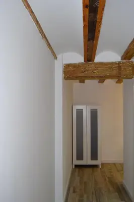 a room with white walls and wooden beams at NWT Central Station Apartments in Valencia