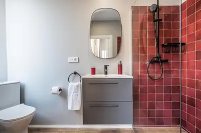 a bathroom with a toilet and a sink and a mirror at L'Arbre in Valencia