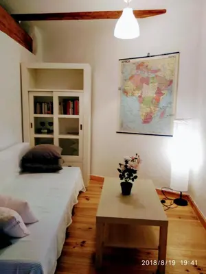 a room with two beds and a table and a map at Valencian Dreams of the Proletariat in Valencia