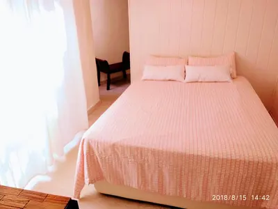 a bedroom with a bed with a white comforter and a window at Valencian Dreams of the Proletariat in Valencia